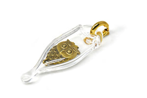Glass capsule charm with antique brass owl inside glass. Approx 1 1/2 inches long by 3/4 inch wide