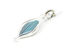 small blown glass charm with cruelty-free blue parrot feather inside