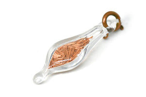 small blown glass charm with cut up rose gold wire inside