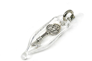 Glass capsule charm with antique silver key inside glass